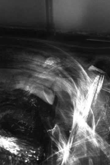 Long-exposure photograph of a dancer in motion — rhythm, light, and psyche